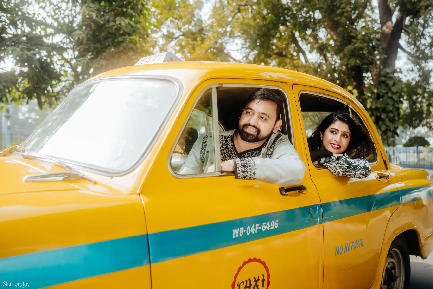 Linisha and Amit in a yellow taxi